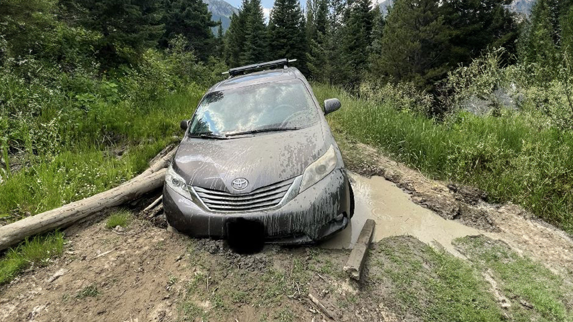 Toyota Sienna stuck, sandwiched in a rut