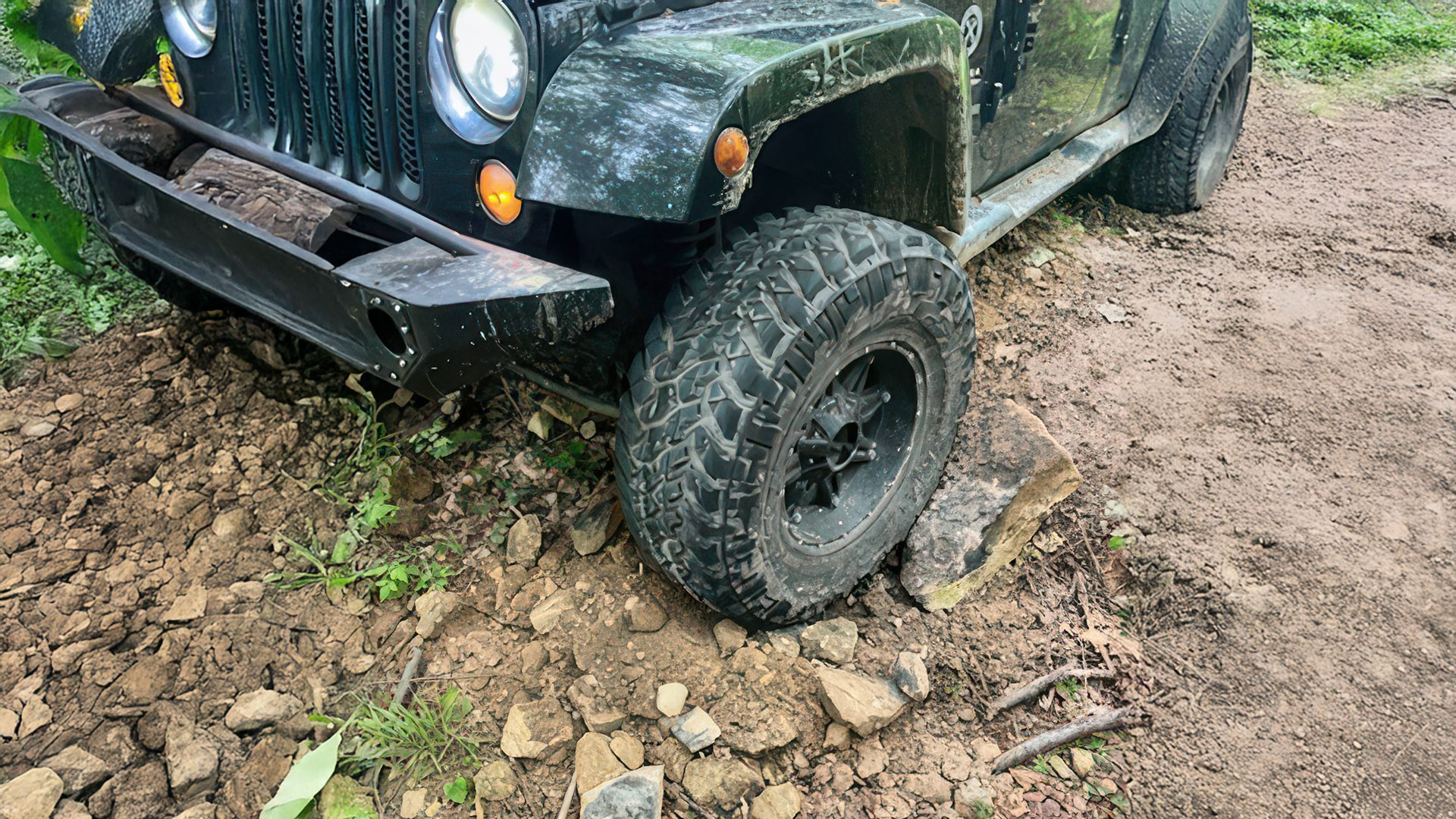 Jeep high centered on a rock bank Jeep high centered on a rock bank